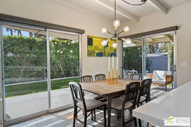 a view of a dining room with furniture window and outside view