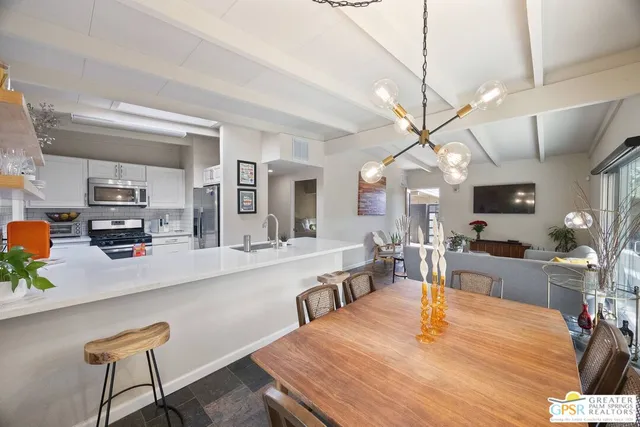 a large kitchen with a table and chairs in it