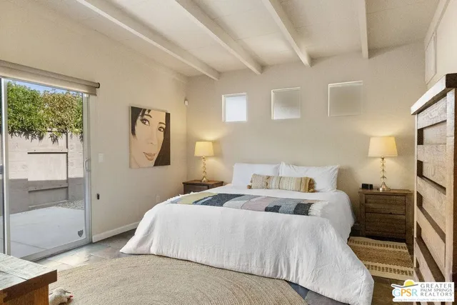 a bed room with a bed mirror and a window