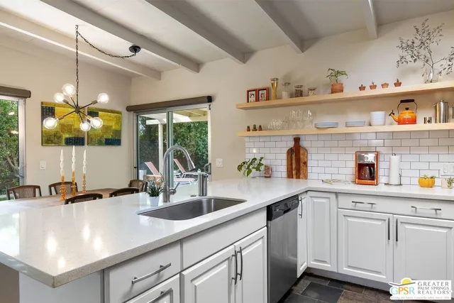 a kitchen with cabinets and window
