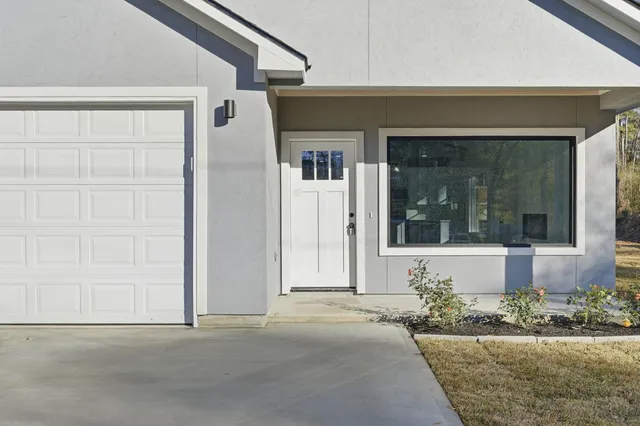a front view of a house with a yard and flowers