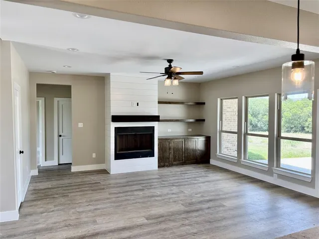 a view of a kitchen with a sink and a large window