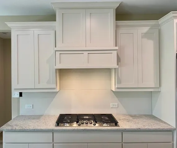 a stove top oven sitting inside of a kitchen