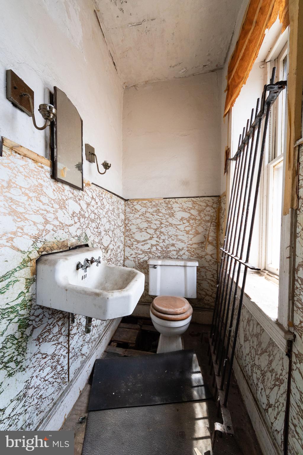 2312 Reed Street Philadelphia, PA 19146 - Photo 13 of 23 a bathroom with a sink a toilet and a mirror