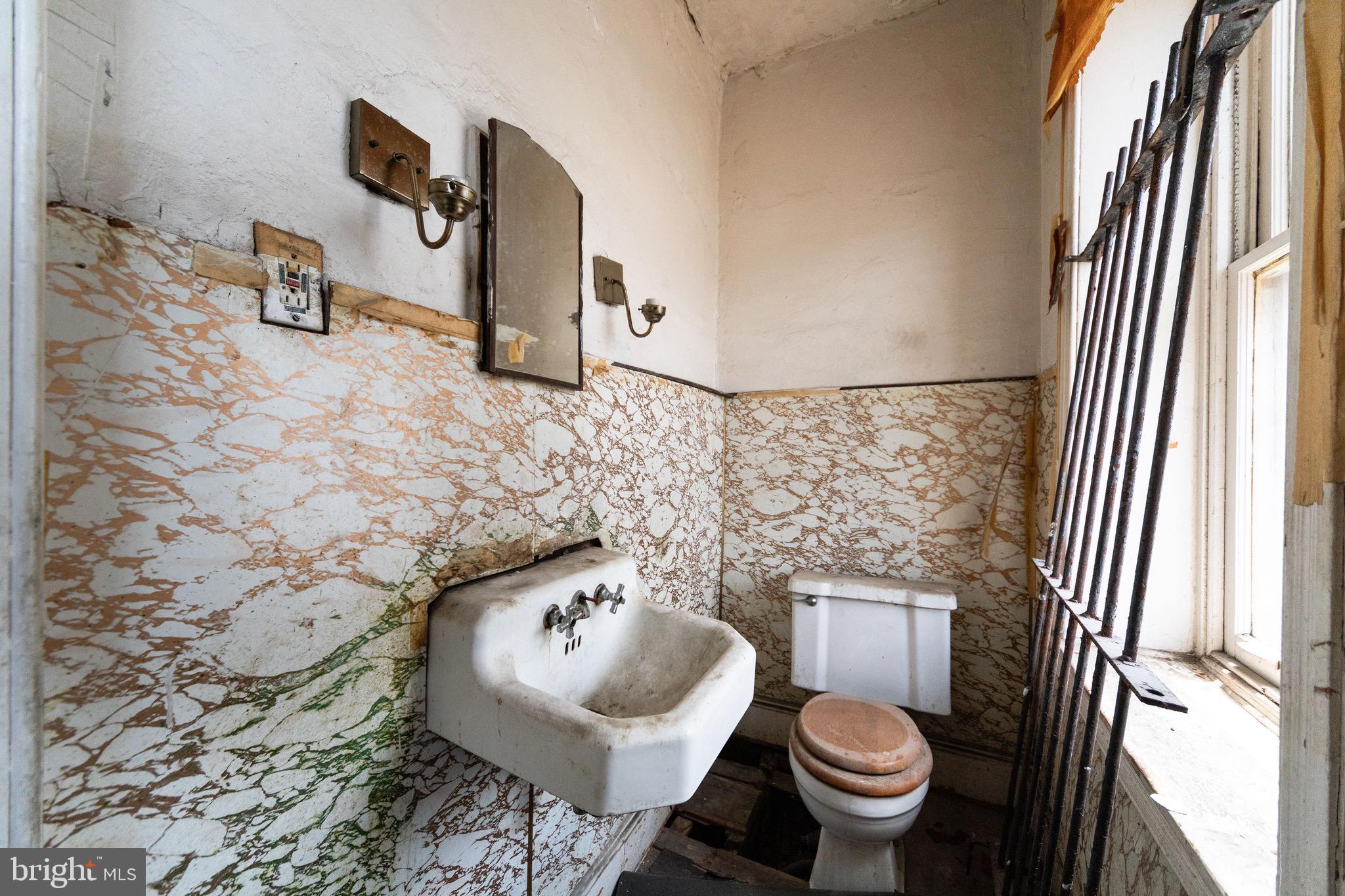 2312 Reed Street Philadelphia, PA 19146 - Photo 14 of 23 a bathroom with a sink and mirror with toilet