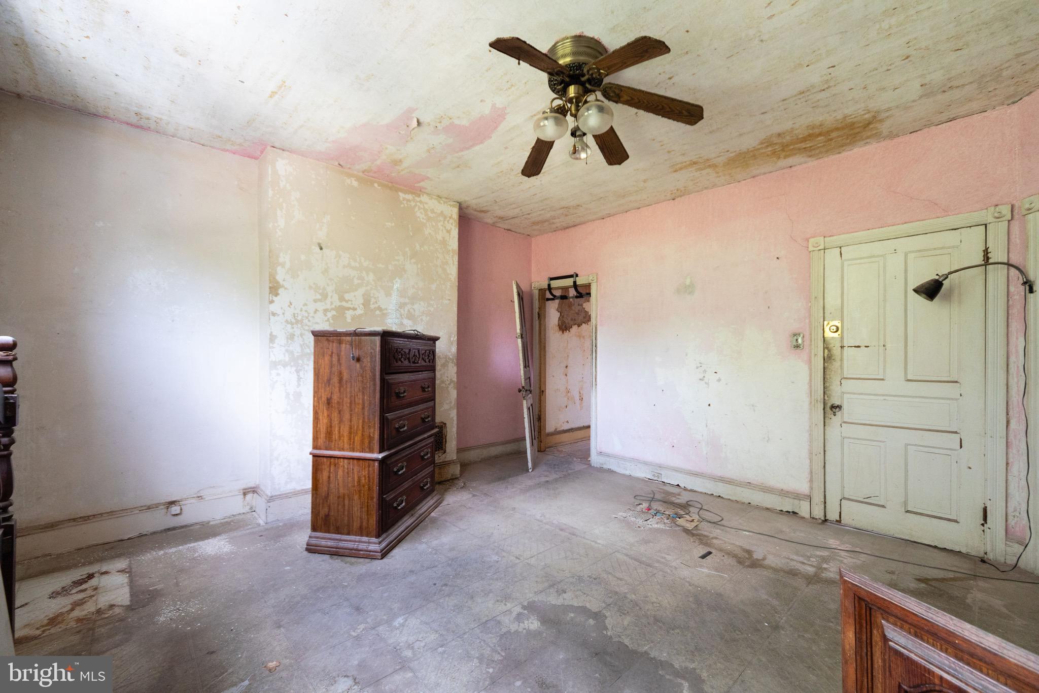 2312 Reed Street Philadelphia, PA 19146 - Photo 10 of 23 a view of a livingroom with a chandelier fan and a kitchen