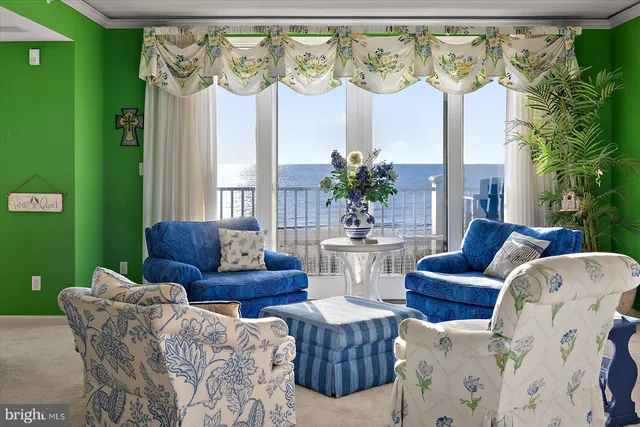 a view of living room filled with furniture and a potted plant