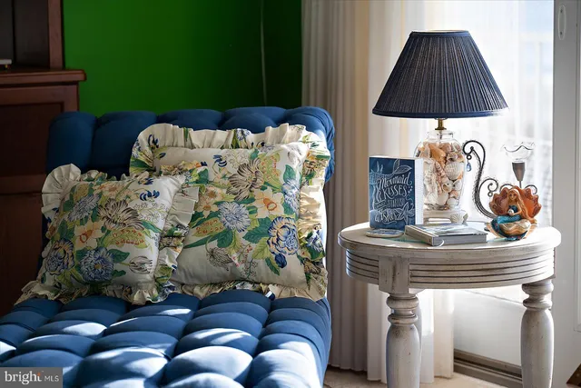 a bedroom with furniture a fireplace and large windows
