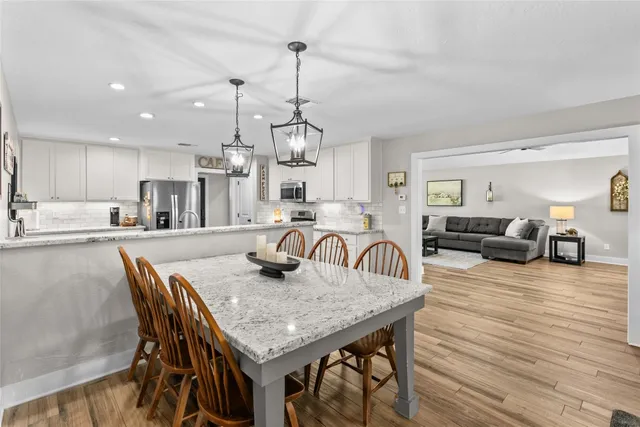a dining room with furniture and wooden floor