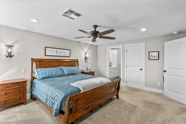 a bedroom with a bed and a ceiling fan