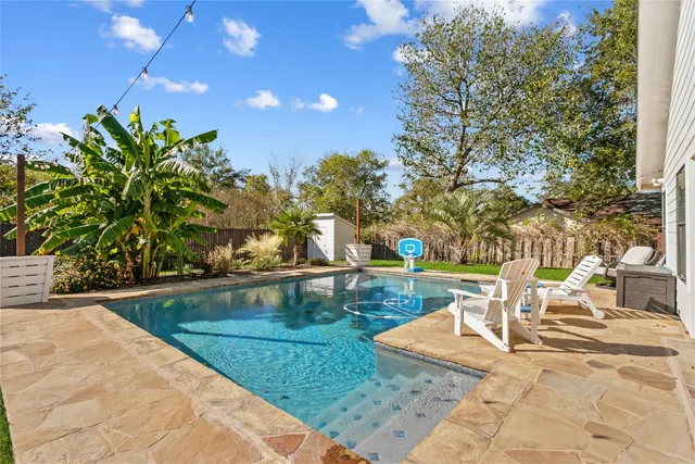 a view of a swimming pool with a patio
