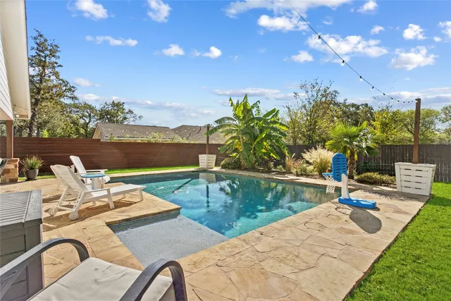 a view of a swimming pool with lounge chairs