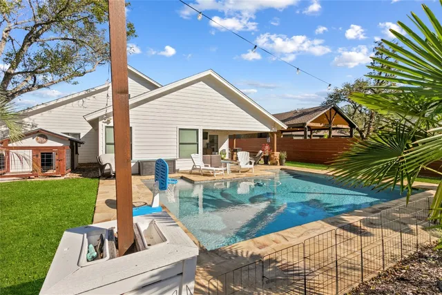 a view of a house with backyard porch and sitting area
