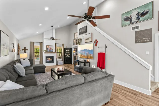 a living room with furniture and wooden floor