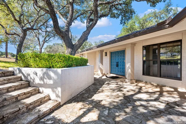 a view of a house with a tree in front