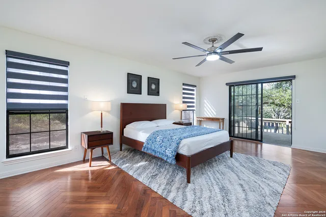 a bedroom with a bed and a large window