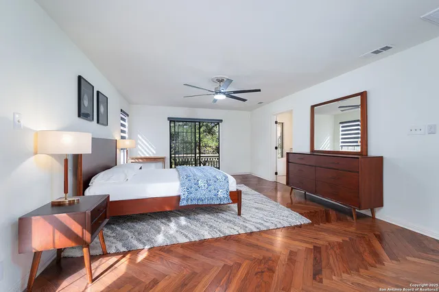 a bedroom with a large bed and a dresser