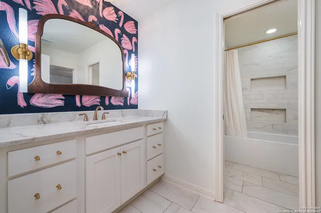 a bathroom with a double vanity sink and a mirror