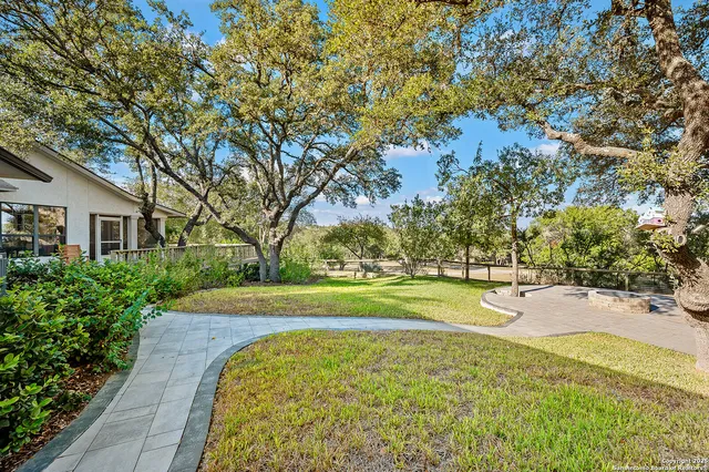 a view of yard with swimming pool and green space