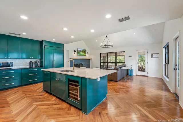 a kitchen with kitchen island stainless steel appliances a sink stove and cabinets