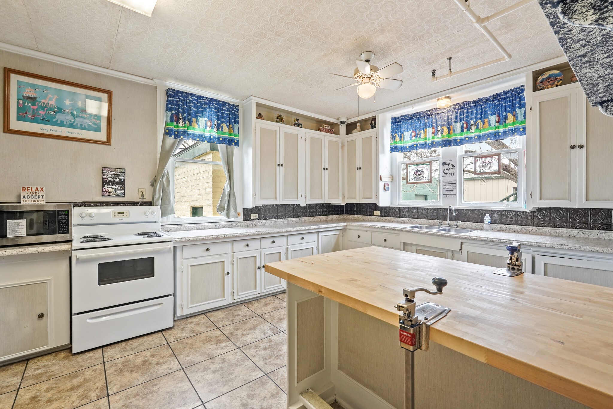 1030 4th Street Rosenberg, TX 77471 - Photo 16 of 39 a kitchen with a stove a sink and a refrigerator
