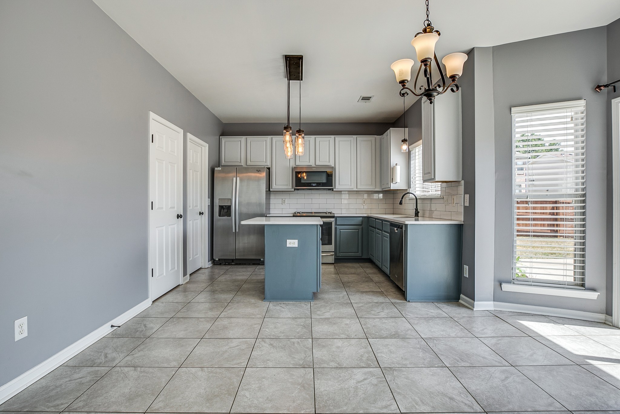 1715 Emma Circle Spring Hill, TN 37174 - Photo 7 of 23 a kitchen with stainless steel appliances a sink a stove a refrigerator cabinets and a window