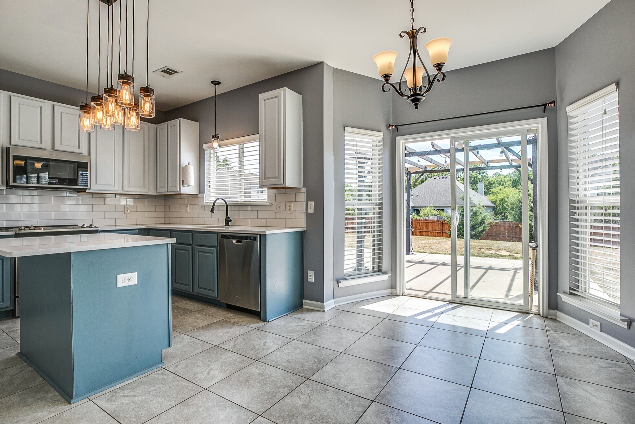 1715 Emma Circle Spring Hill, TN 37174 - Photo 9 of 23 a kitchen with a sink a counter top space cabinets and stainless steel appliances