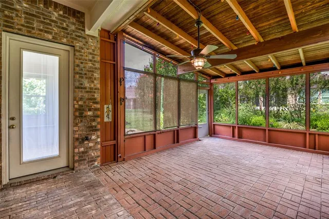 a view of a room with wooden floor and windows