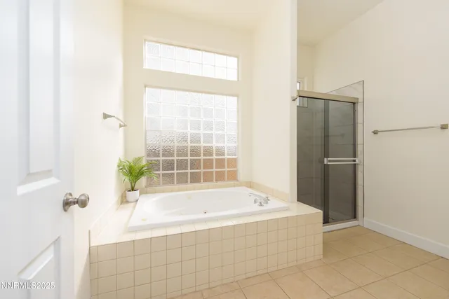 a white bath tub sitting next to a shower