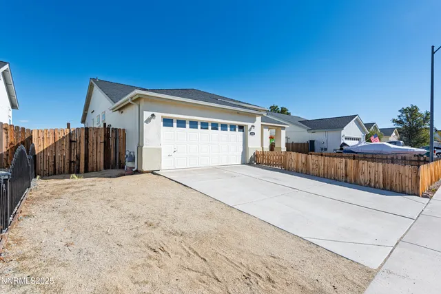 a view of backyard with a wooden fence
