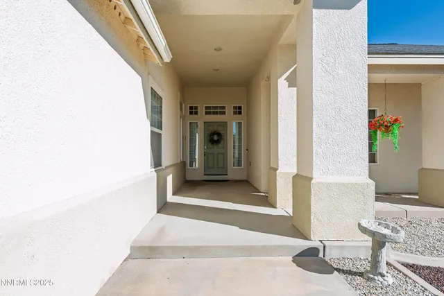 a view of a hallway with wooden floor and furniture