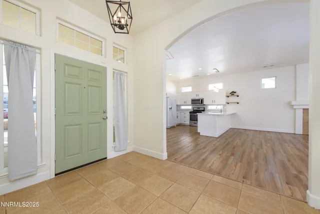 a view of kitchen with a refrigerator and a sink
