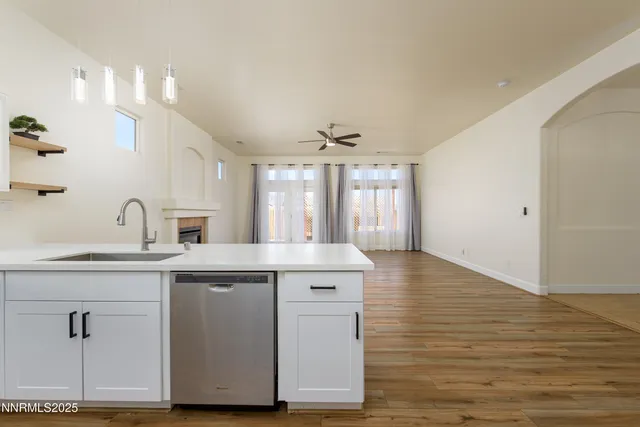a kitchen with a sink cabinets and wooden floor