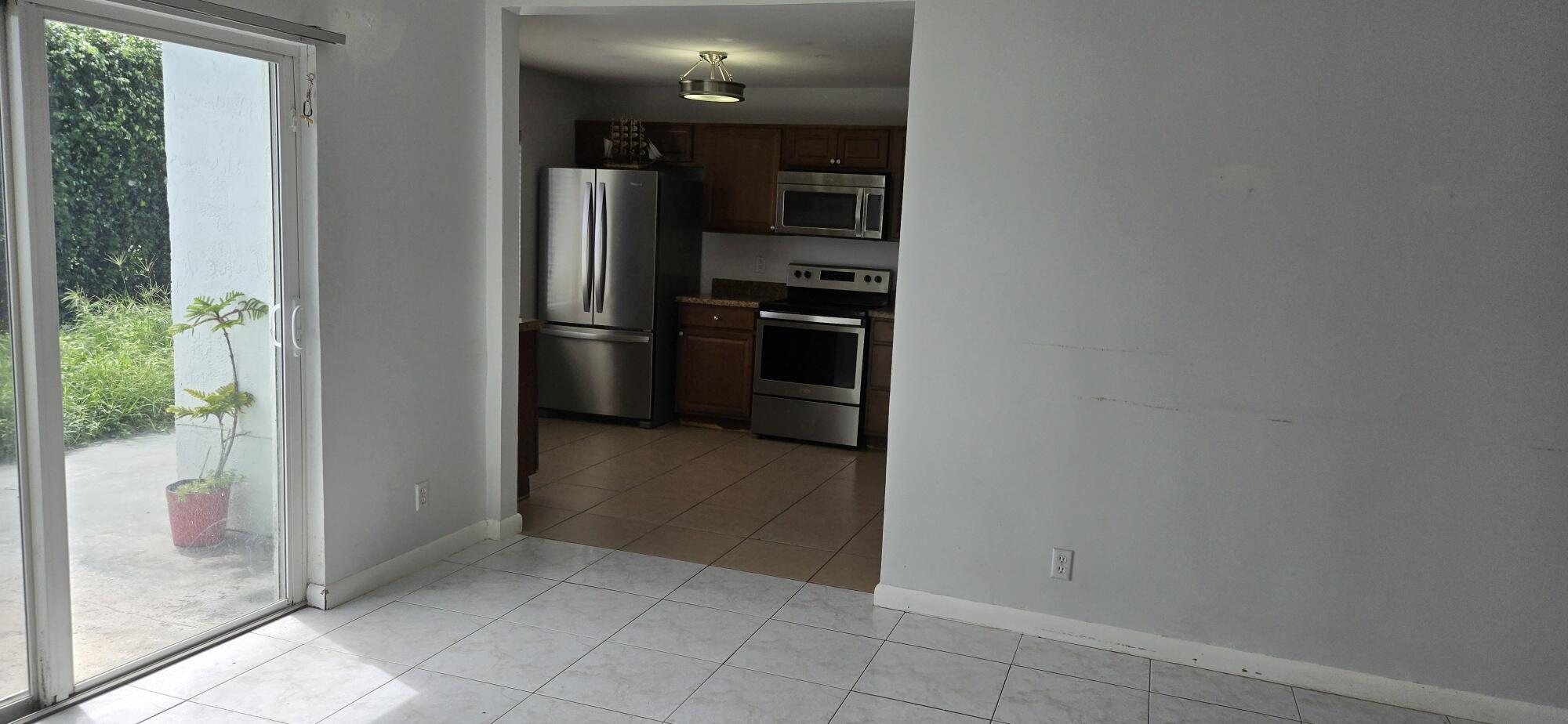 6158 Westfall Road Lake Worth, FL 33463 - Photo 14 of 24 a view of a kitchen from the hallway