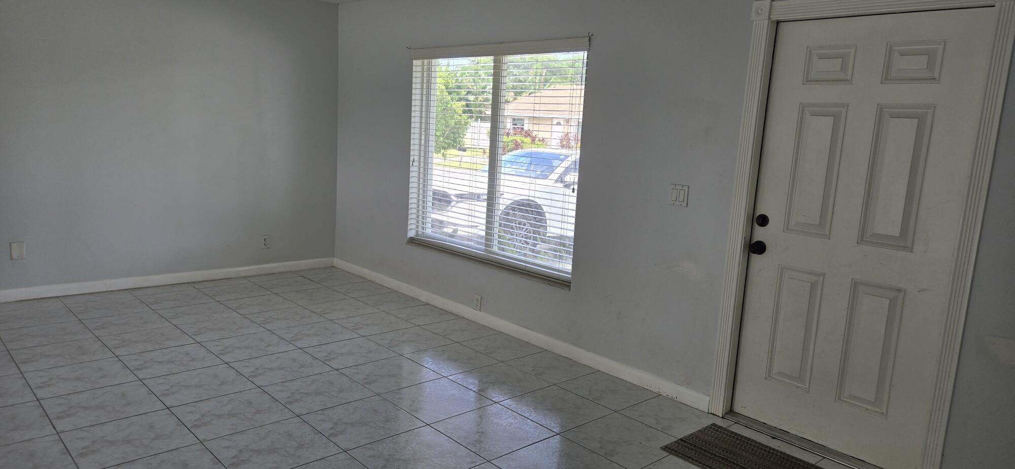 6158 Westfall Road Lake Worth, FL 33463 - Photo 16 of 24 a view of an empty room with a window