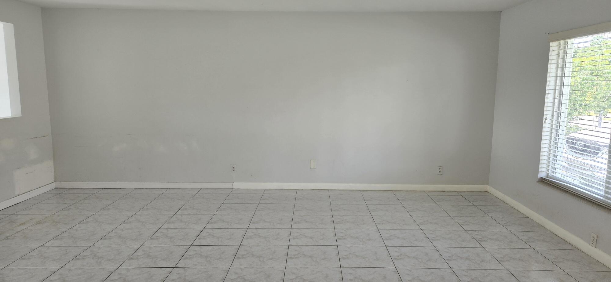 6158 Westfall Road Lake Worth, FL 33463 - Photo 17 of 24 wooden floor in an empty room with a window