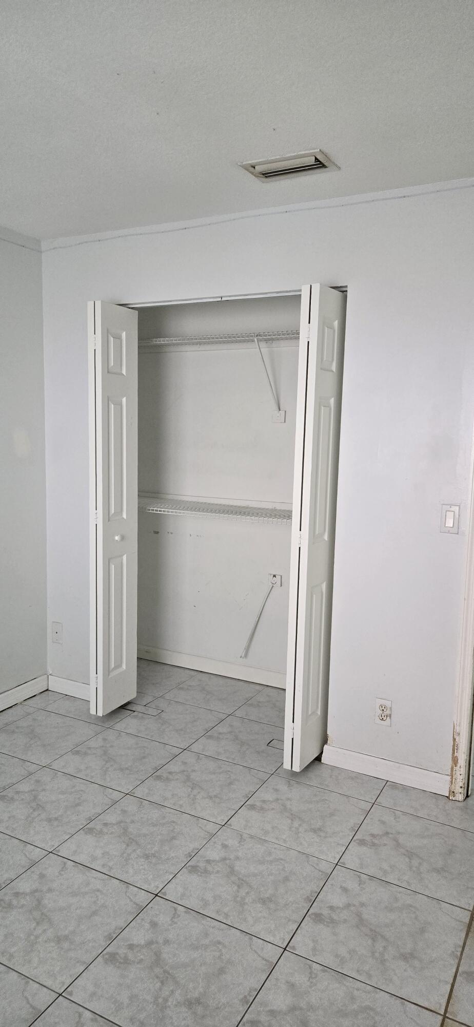 6158 Westfall Road Lake Worth, FL 33463 - Photo 22 of 24 an empty room with staircase