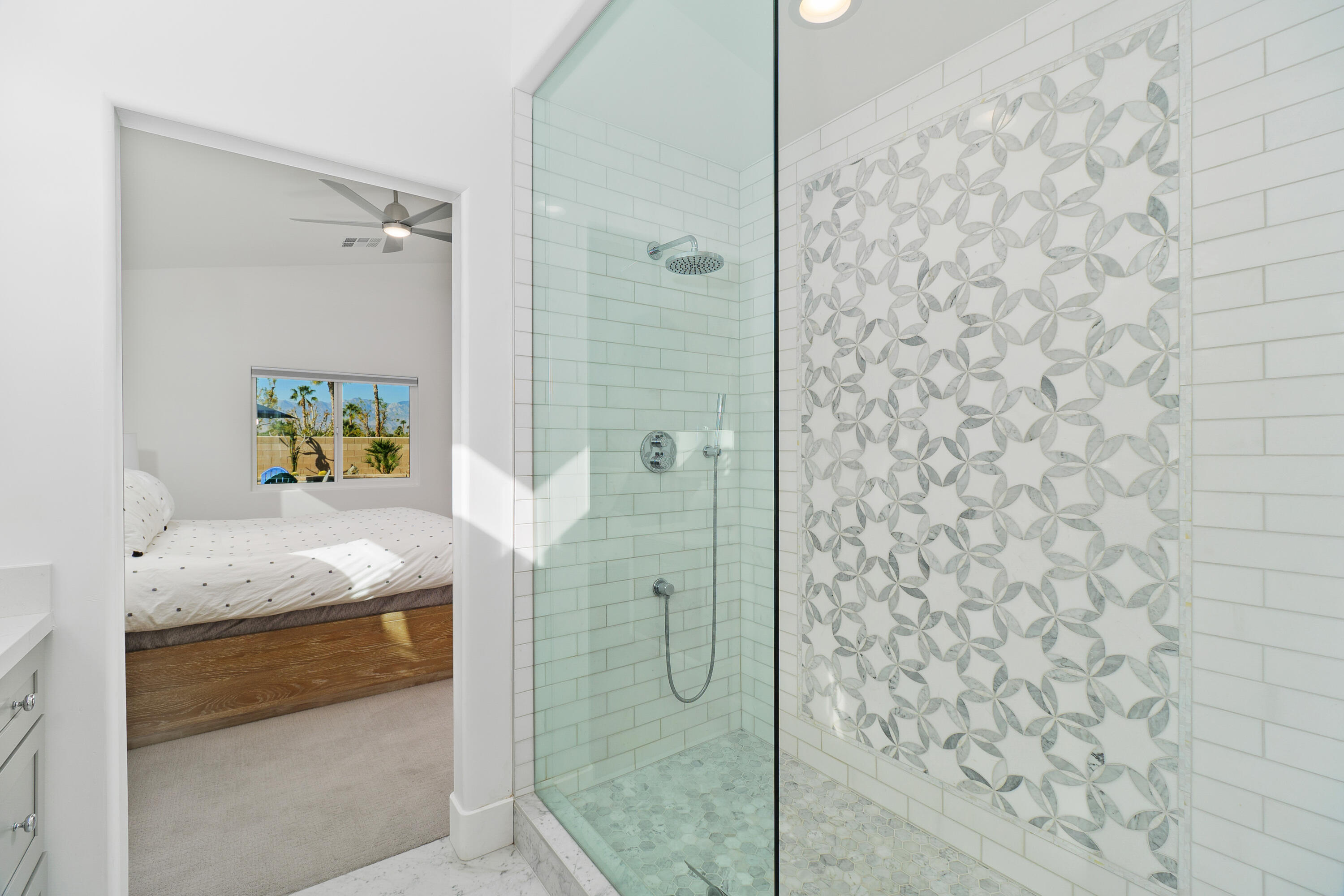 45703 Crosswater Street Indio, CA 92201 - Photo 18 of 41 a bathroom with a granite countertop sink a mirror and shower