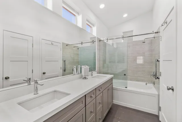 a bedroom with a bed and a flat tv screen on dresser