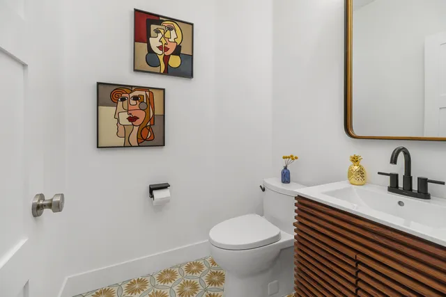 a view of a dining room with furniture a livingroom and chandelier