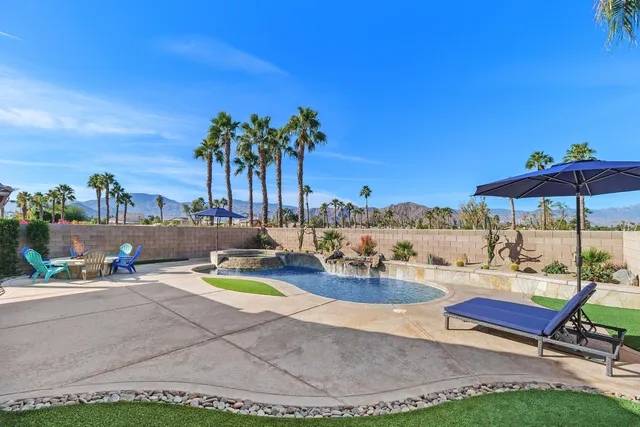 a view of a chairs and table in patio