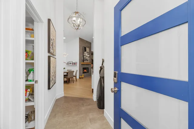 a living room with furniture fireplace and a large window