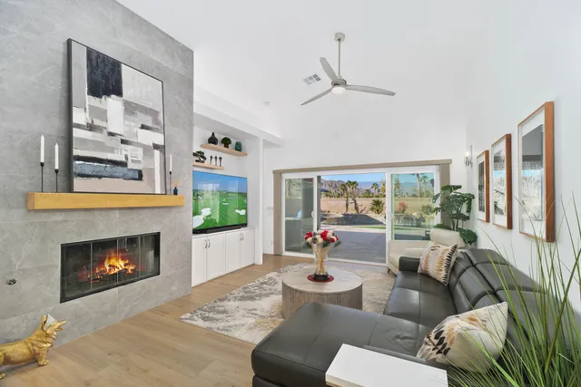 a dining room with furniture potted plants and a chandelier