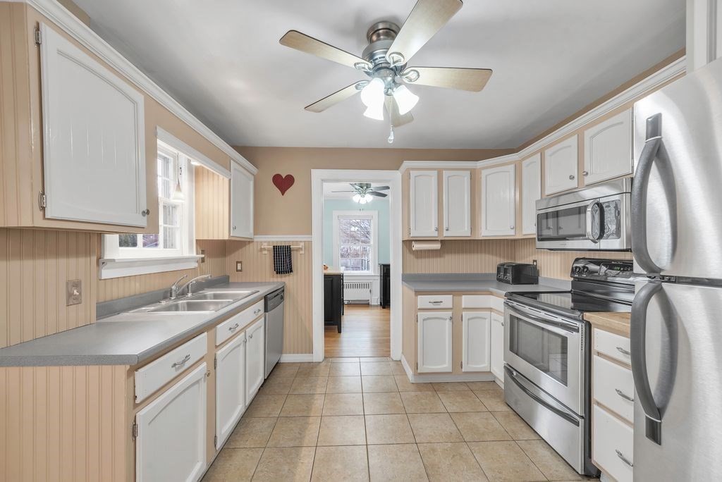 106 Granville Road Westfield, MA 01085 - Photo 21 of 42 a kitchen with stainless steel appliances a stove sink cabinets and refrigerator