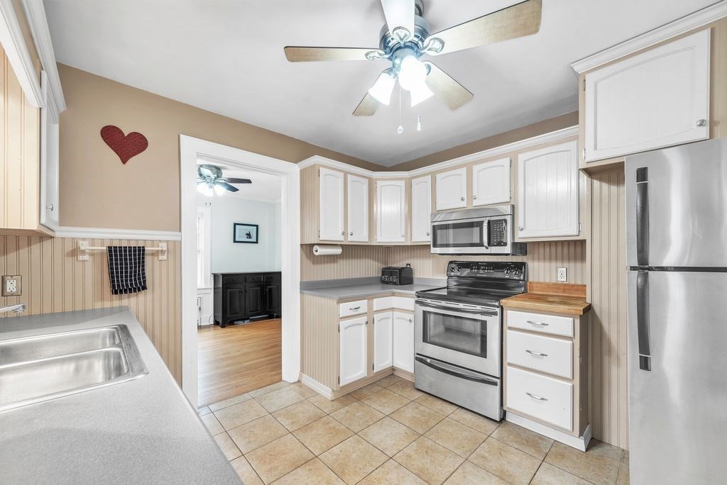 106 Granville Road Westfield, MA 01085 - Photo 22 of 42 a kitchen with white cabinets and stainless steel appliances