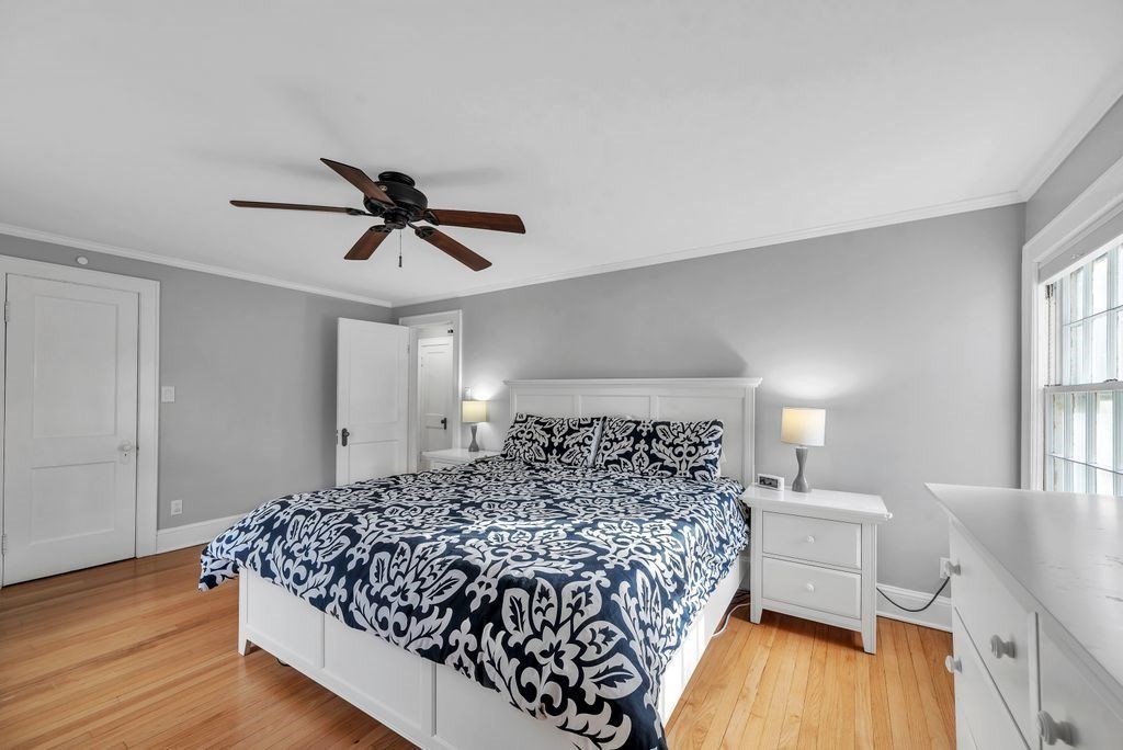 106 Granville Road Westfield, MA 01085 - Photo 29 of 42 a bed sitting in a bedroom next to a window and a chandelier