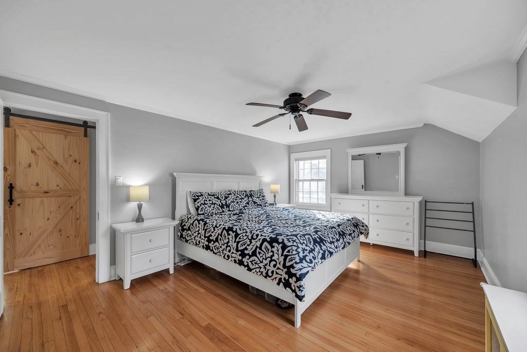 106 Granville Road Westfield, MA 01085 - Photo 30 of 42 a bedroom with a bed chandelier and a window