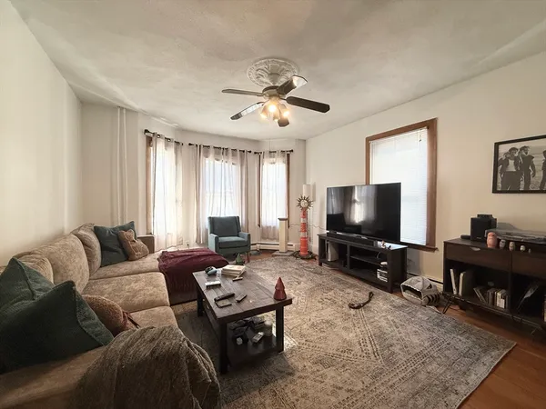 a living room with furniture and a flat screen tv