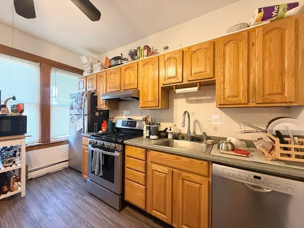 a kitchen with stainless steel appliances granite countertop a sink stove and cabinets