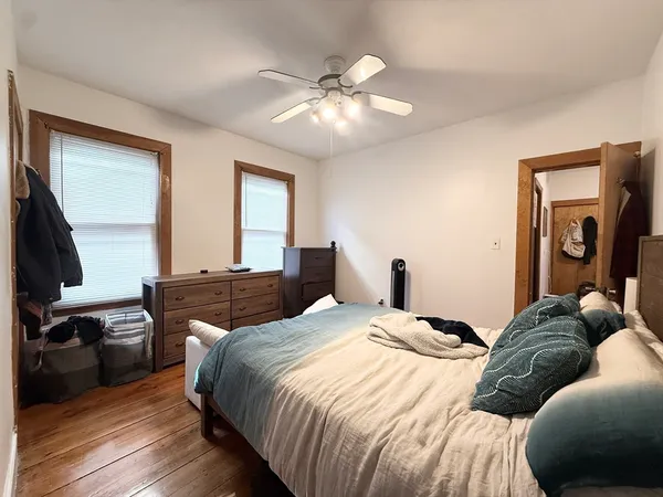 a bedroom with a bed and a chandelier